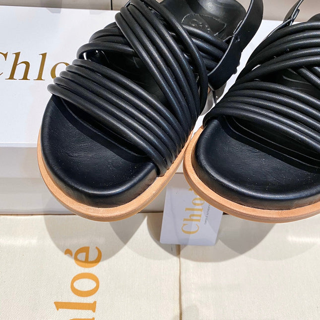 CROSS STRAP SANDAL IN BLACK RUBBER WITH GOLD HARDWARE